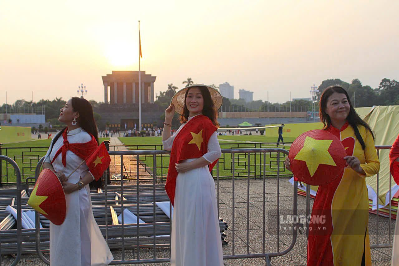 Hầu hết các thiếu nữ đều lựa chọn trang phục đơn giản với áo dài trắng, mang theo nón lá, cờ Tổ quốc để check-in khu vực trung tâm.