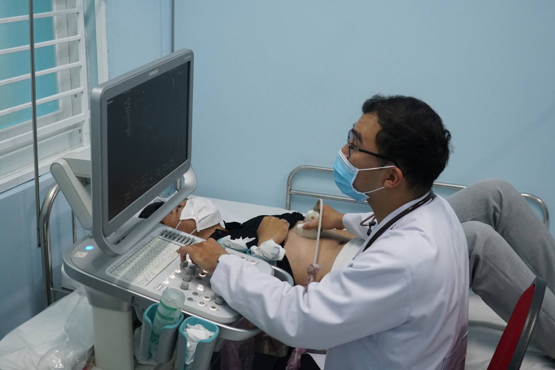 Bác sĩ Hải siêu âm cho người bệnh. Ảnh: Thanh Chân