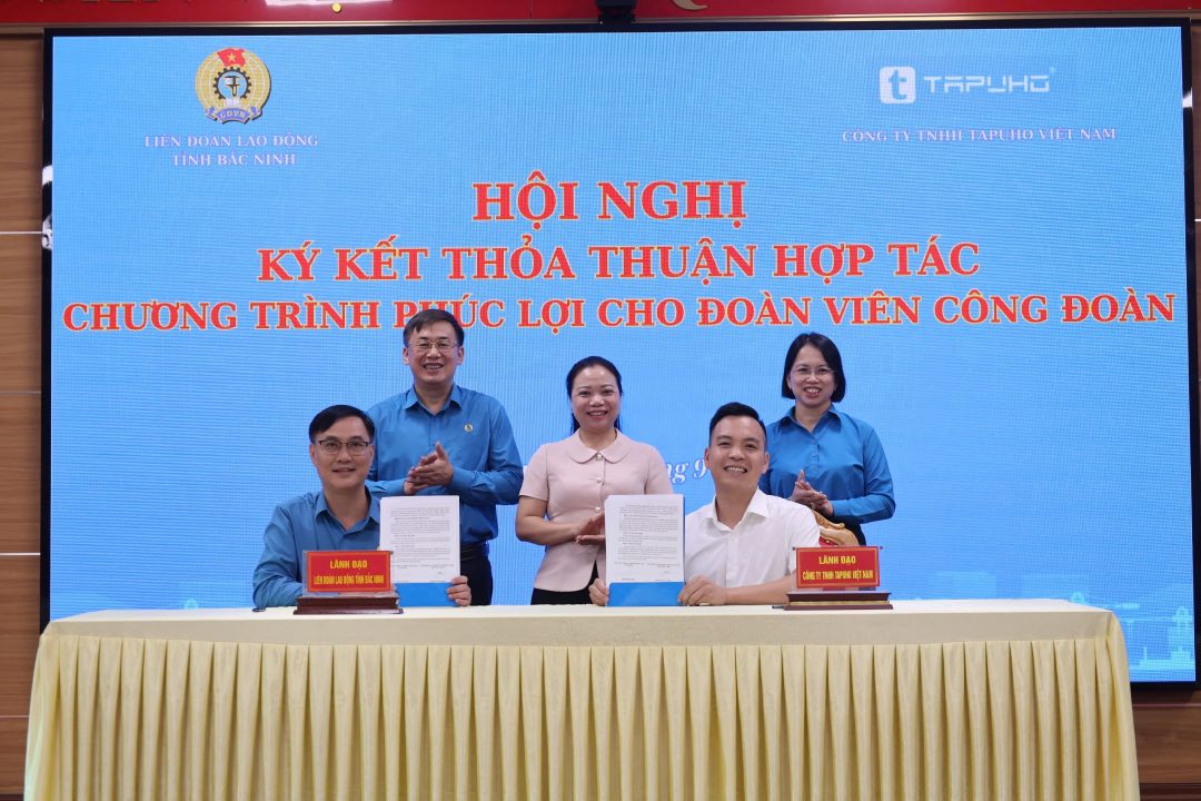 Lãnh đạo Liên đoàn Lao động tỉnh và đại diện lãnh đạo Công ty trách nhiệm hữu hạn Tapuho ký kết thỏa thuận hợp tác. Ảnh: Quyết Chiến