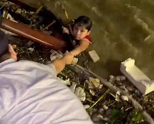 Phát hiện cháu bé trôi giữa dòng nước xiết dưới chân cầu Rồng Đà Nẵng đêm khuya, người dân hợp sức ứng cứu. Ảnh: Trường An