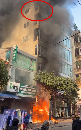 Hiện trường vụ cháy. Thời điểm ngọn lửa bùng lên vẫn có người trên tầng cao của tòa nhà (khoanh đỏ). Ảnh: Trần Thùy